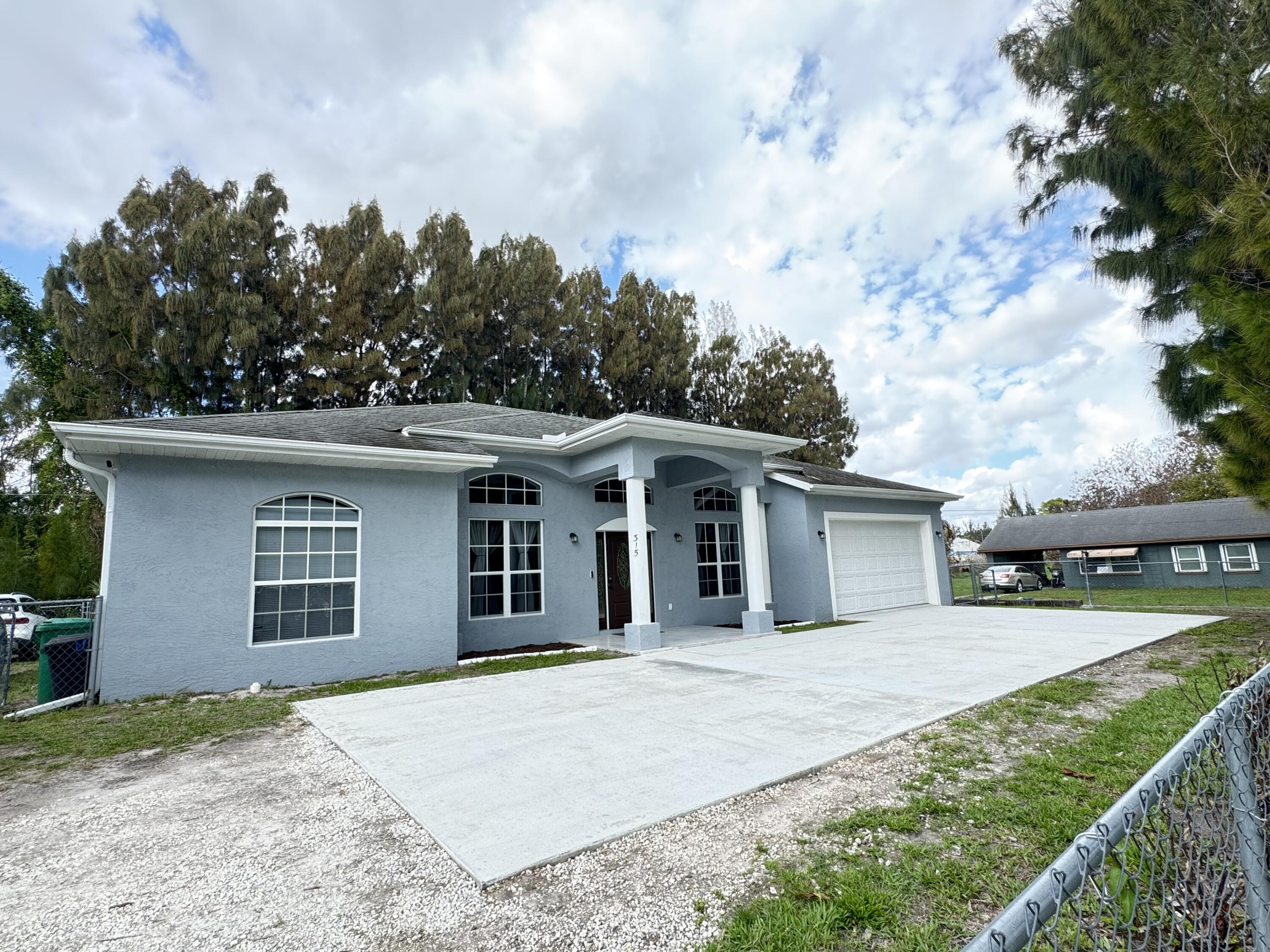 315 Kaye Street Fort Pierce, FL 34947 - Photo 8 of 66 a front view of a house with a garden