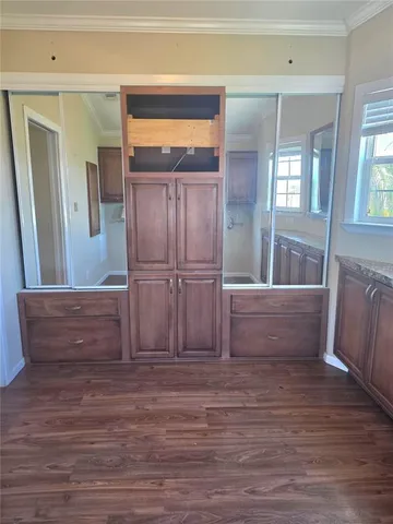 a view of a room with wooden floor and a window