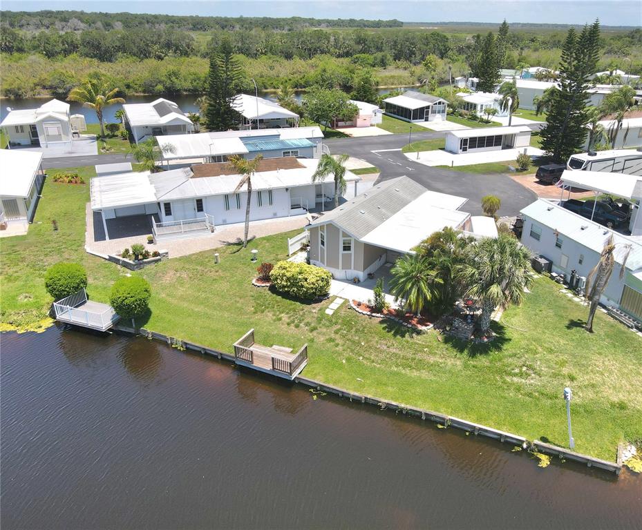 14280 Northeast 124th Avenue, Unit 242 Okeechobee, FL 34974 - Photo 15 of 19 an aerial view of residential houses with outdoor space and swimming pool