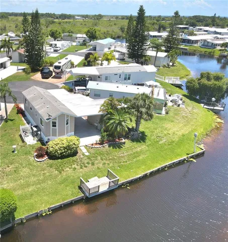 an aerial view of residential houses with outdoor space and swimming pool