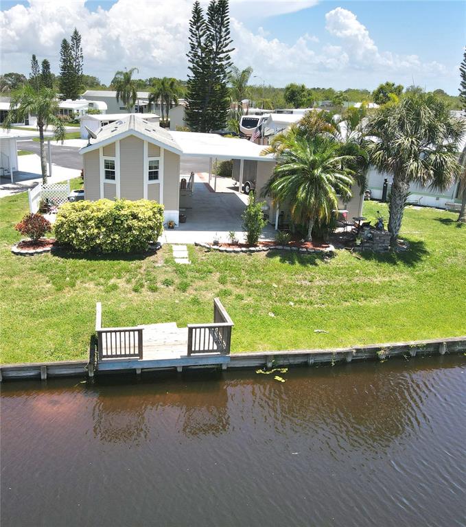 14280 Northeast 124th Avenue, Unit 242 Okeechobee, FL 34974 - Photo 17 of 19 an aerial view of residential houses with outdoor space and swimming pool