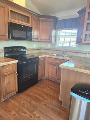 a kitchen with stainless steel appliances granite countertop a sink stove and microwave