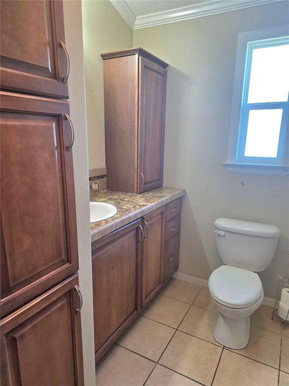 14280 Northeast 124th Avenue, Unit 242 Okeechobee, FL 34974 - Photo 8 of 19 a bathroom with a toilet a sink a vanity and window