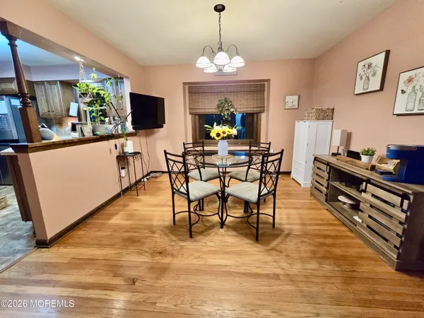 a view of a dining room with furniture and wooden floor