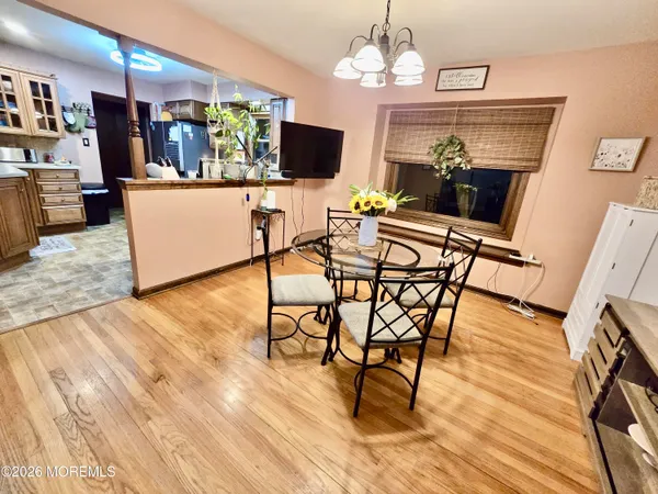 a dining room with furniture and wooden floor