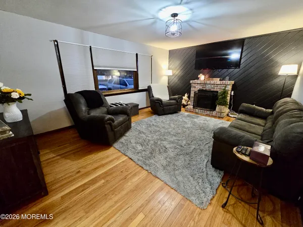 a living room with furniture a fireplace and a flat screen tv