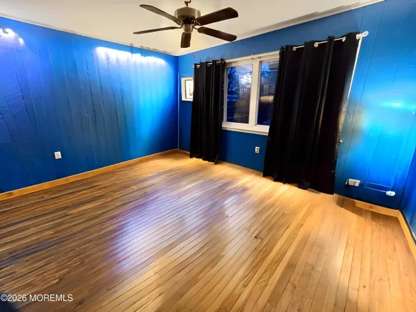 a bedroom with a bed dresser and a large mirror