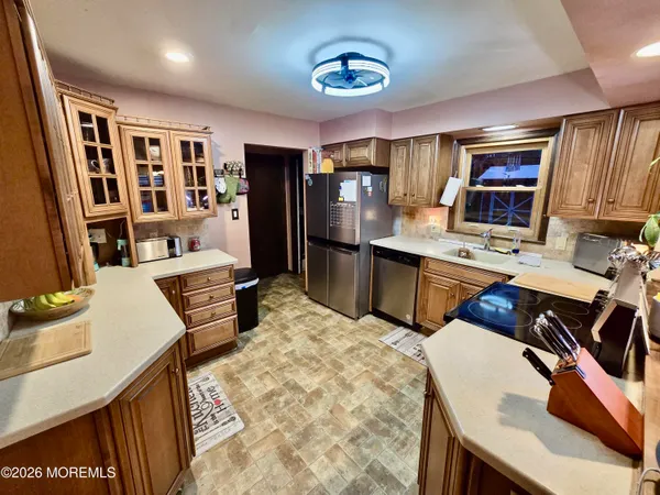a kitchen with a refrigerator a sink and a stove