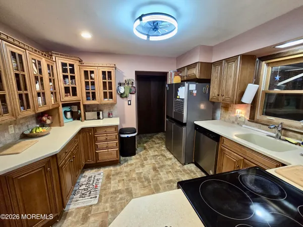 a kitchen with a sink stove and refrigerator