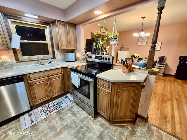 a kitchen with stainless steel appliances a stove a refrigerator and a sink