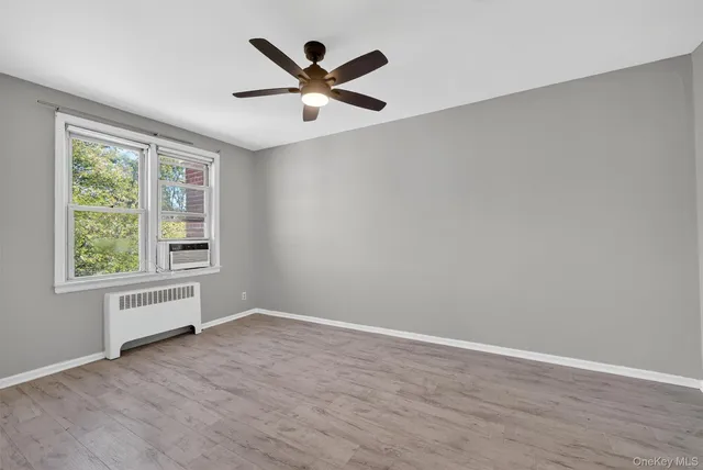 wooden floor in an empty room with a window