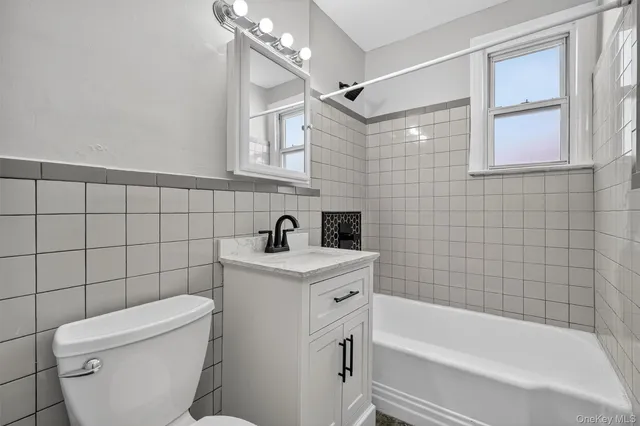 a white bath tub sitting next to a white toilet