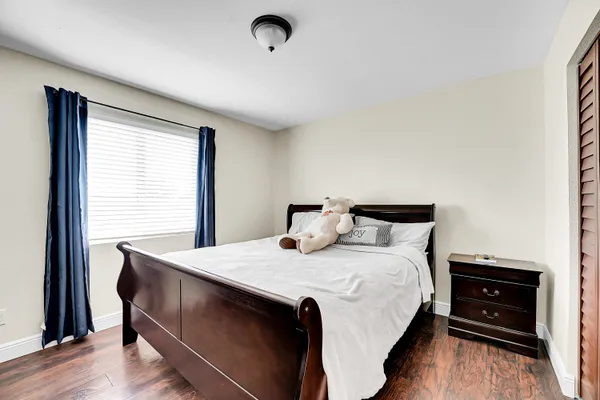 a bedroom with a bed and a dresser