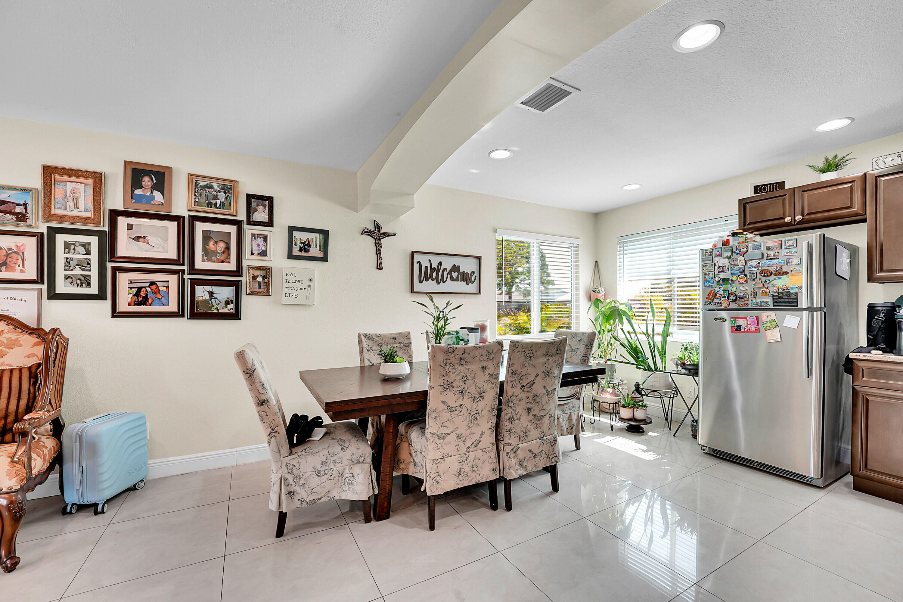 2856 Harson Way Fort Pierce, FL 34946 - Photo 17 of 37 a dining room with furniture a refrigerator and a bookshelf