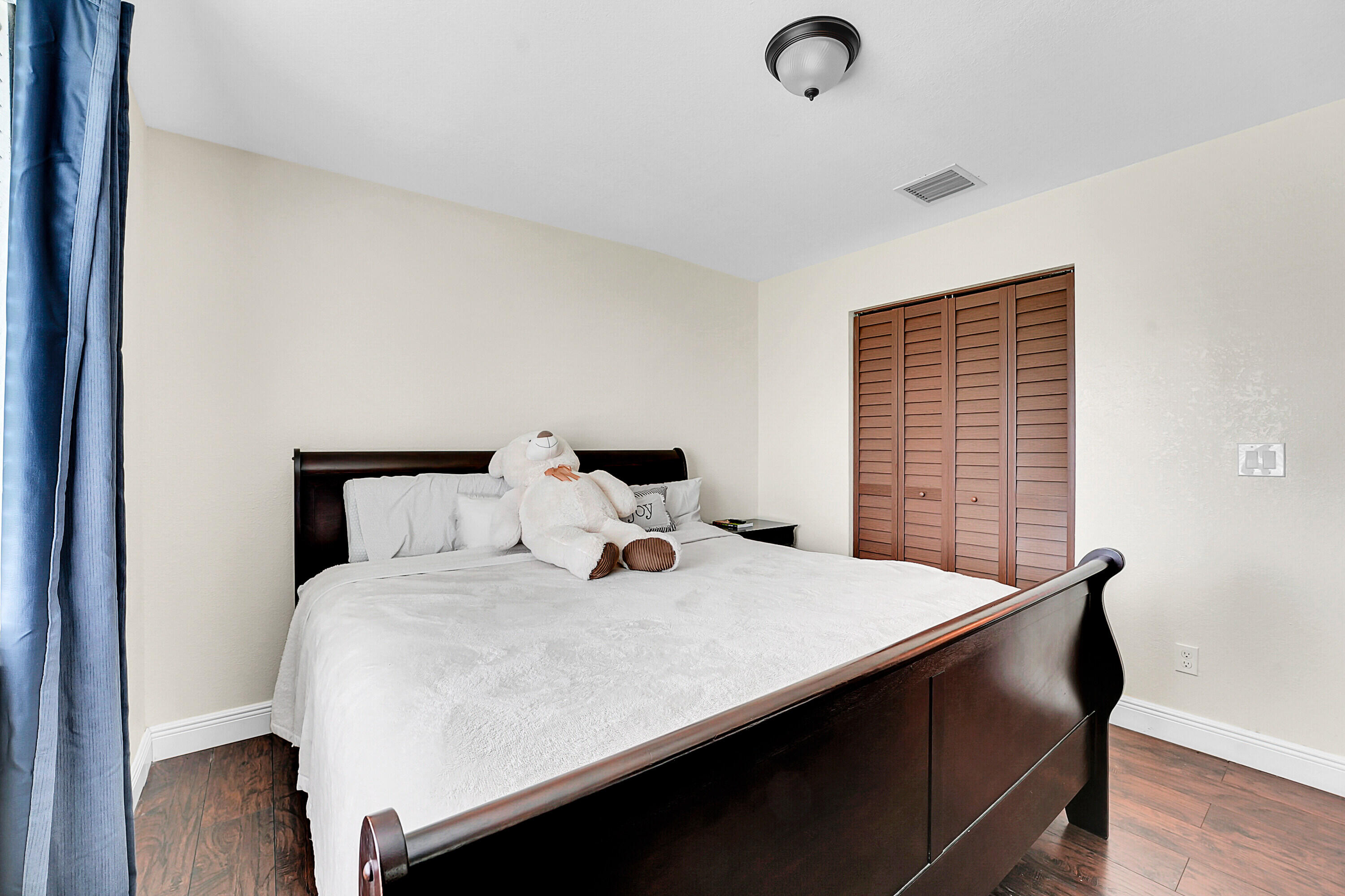 2856 Harson Way Fort Pierce, FL 34946 - Photo 2 of 37 a bedroom with a bed and a window