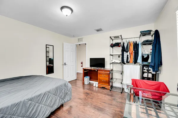 a bedroom with a bed and a flat screen tv
