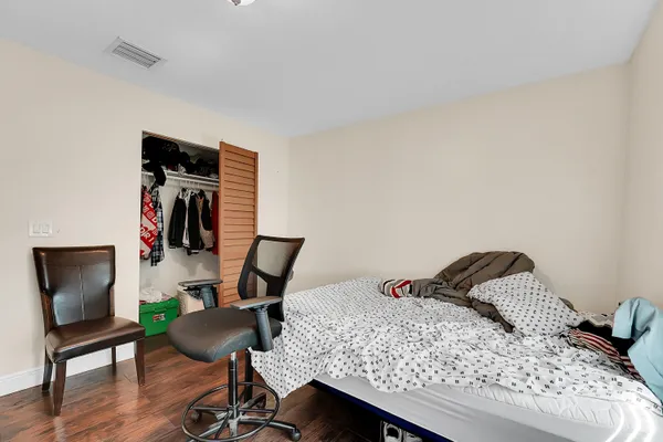 a bedroom with a bed and a chair