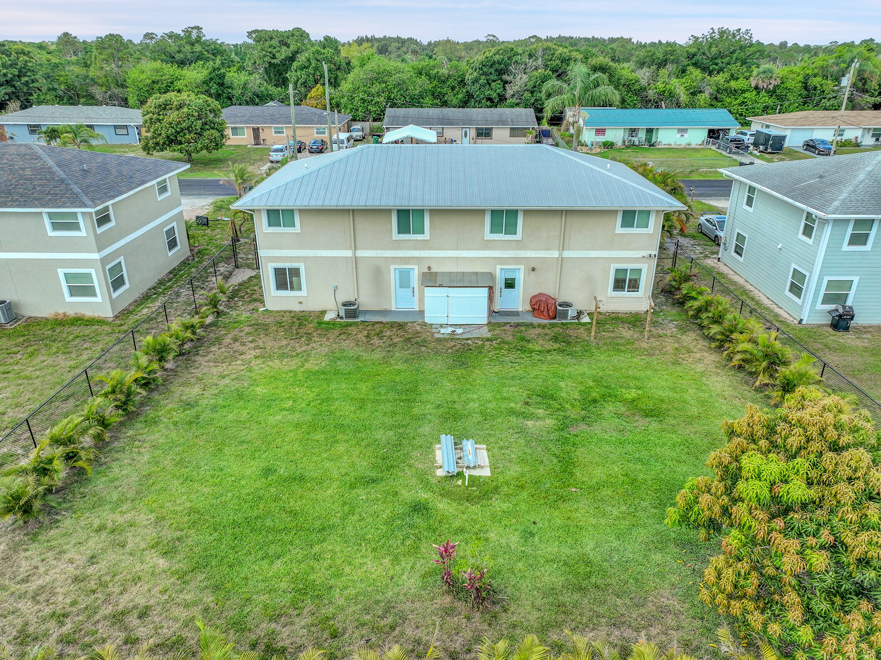 2856 Harson Way Fort Pierce, FL 34946 - Photo 3 of 37 a aerial view of a house with table and chairs under an umbrella