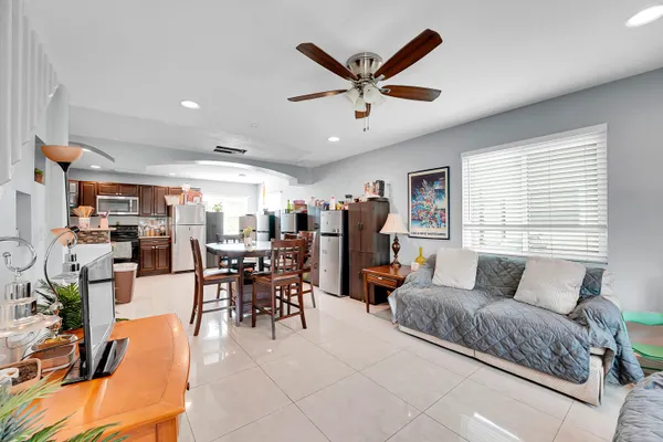 a living room with furniture and kitchen view