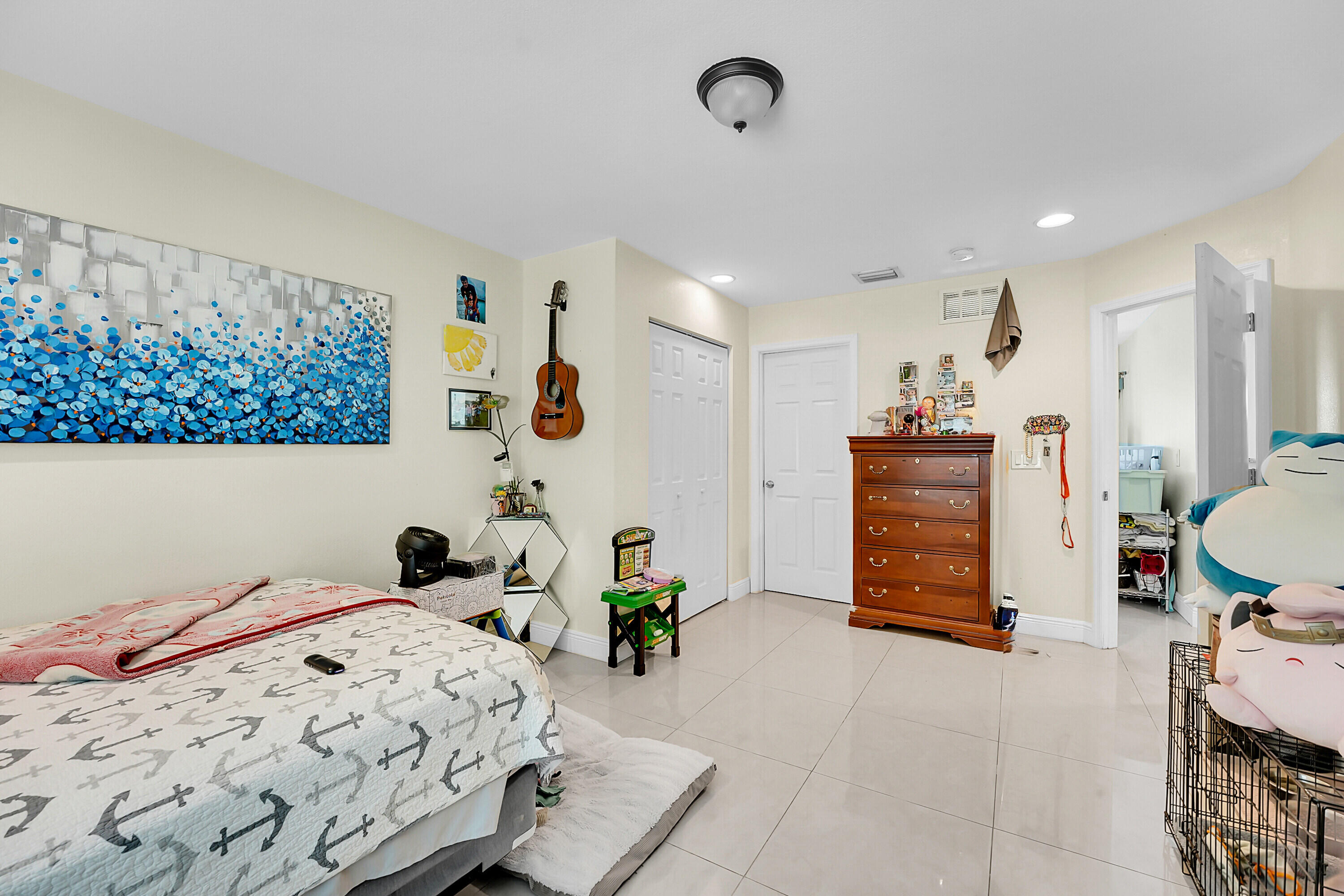 2856 Harson Way Fort Pierce, FL 34946 - Photo 33 of 37 a bedroom that has a bed and a chair in it