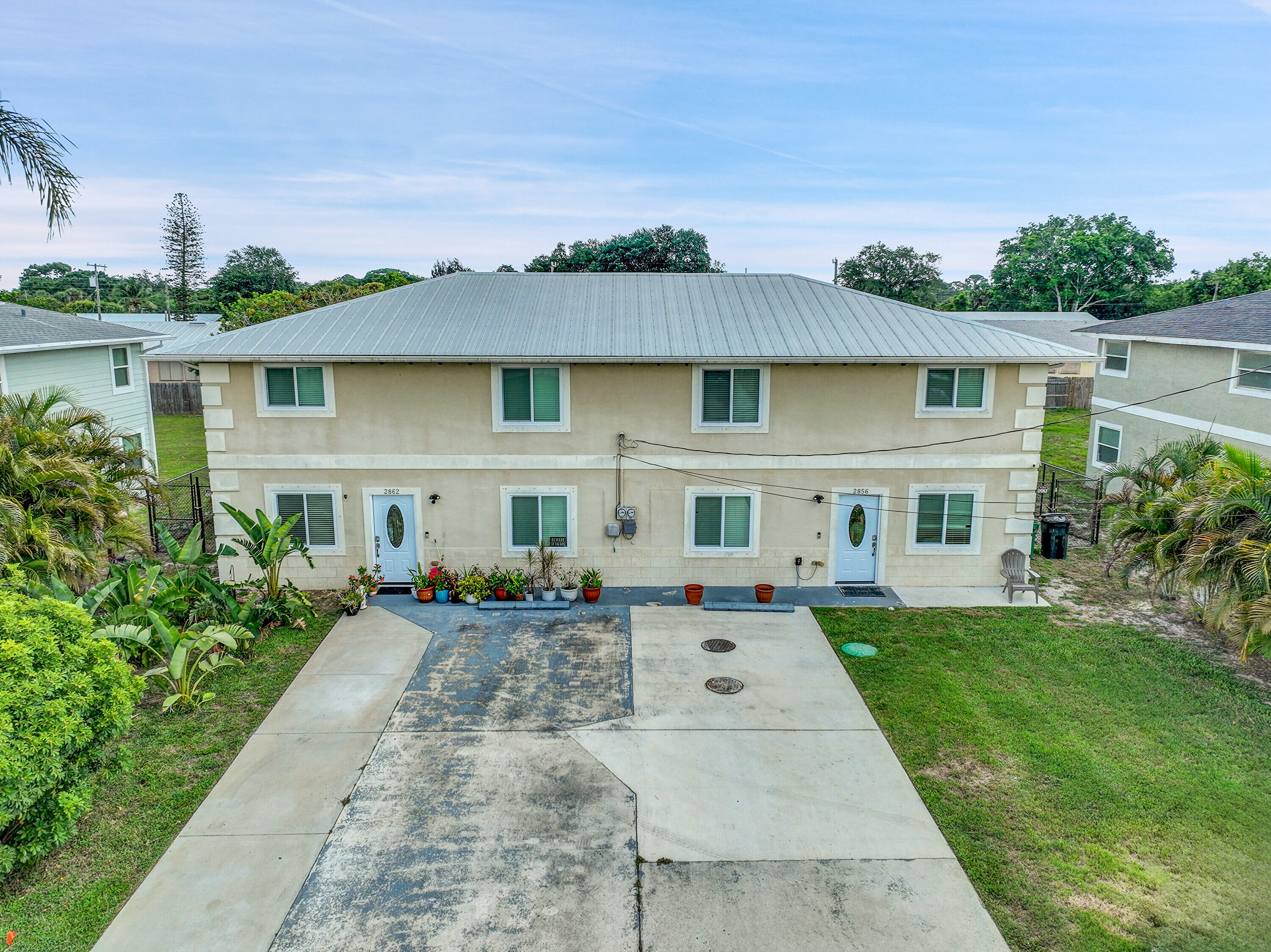 2856 Harson Way Fort Pierce, FL 34946 - Photo 5 of 37 a front view of a house with a yard