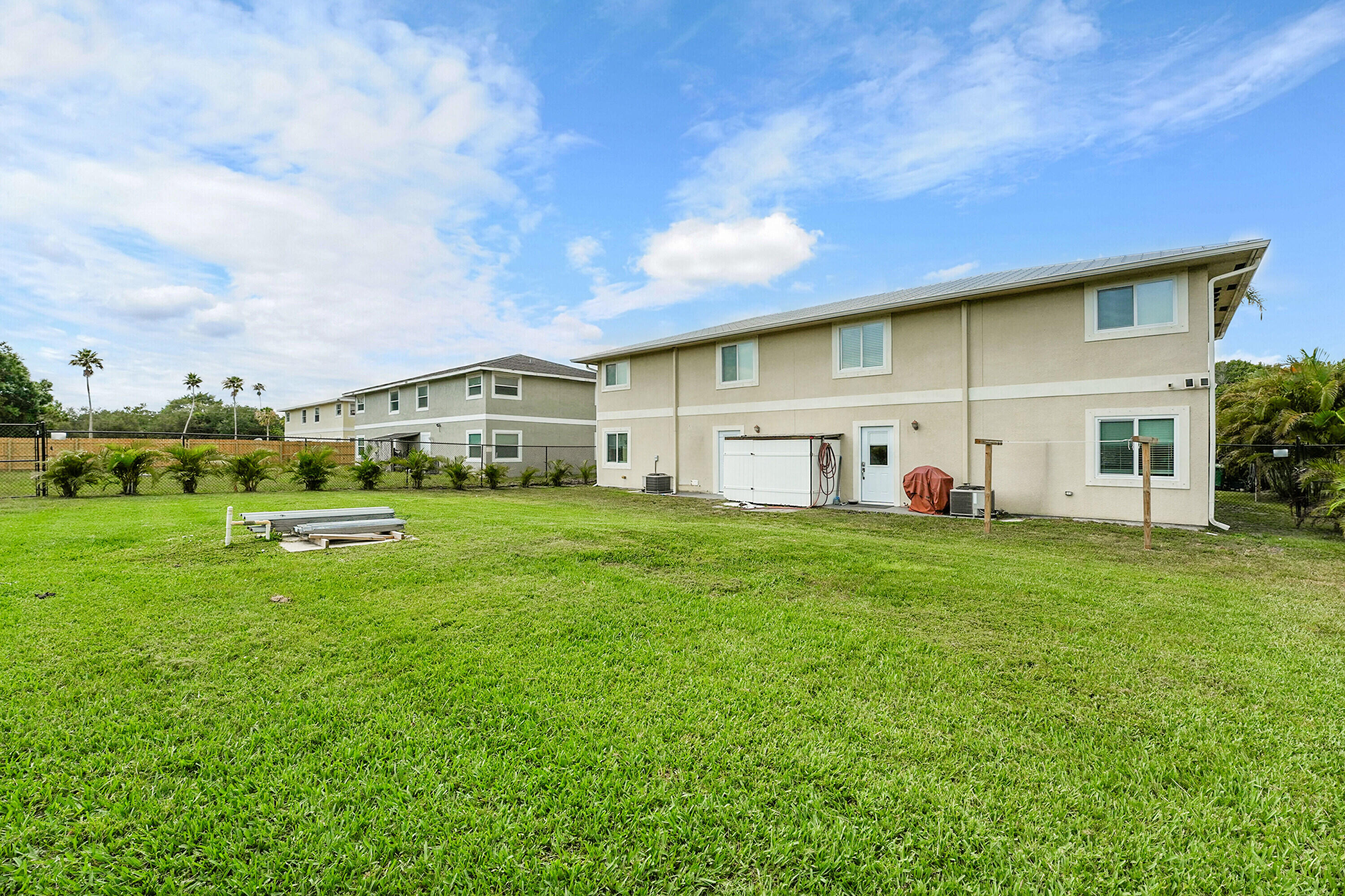 2856 Harson Way Fort Pierce, FL 34946 - Photo 6 of 37 a front view of a house with a yard and garage