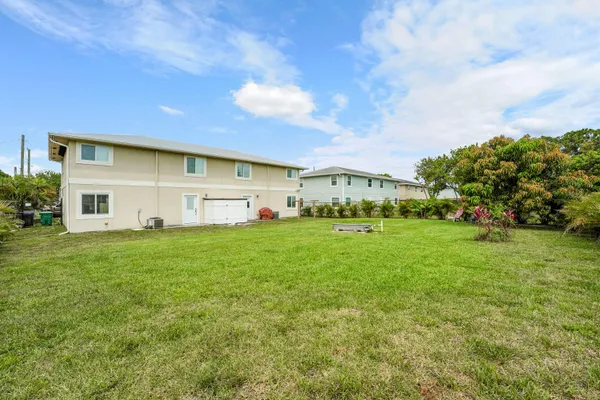 a view of an house with backyard space and garden