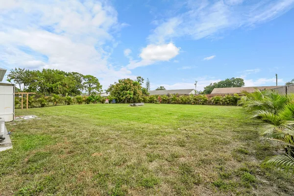 a view of a green field with wooden fence