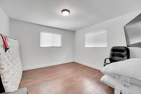 a view of livingroom with workspace and windows