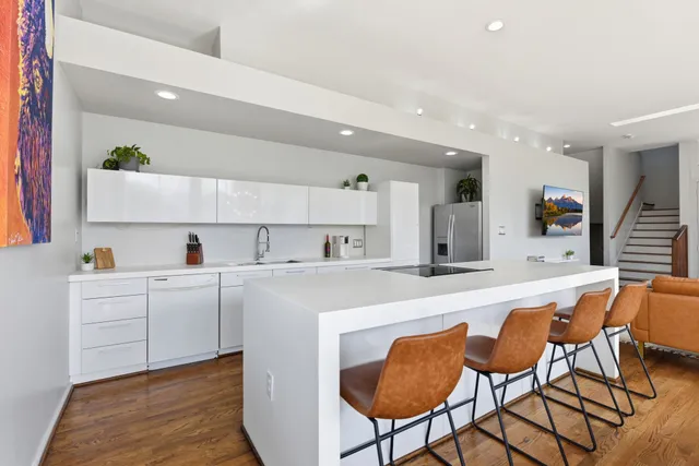 a large kitchen with a table and chairs