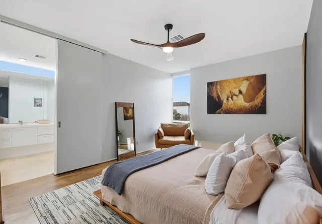 a bedroom with a bed and wooden floor