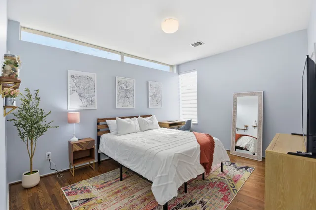 a bedroom with a bed and a dresser