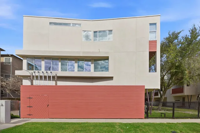a front view of a building with a garden