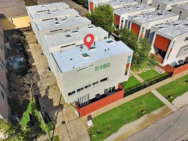an aerial view of multiple house with yard