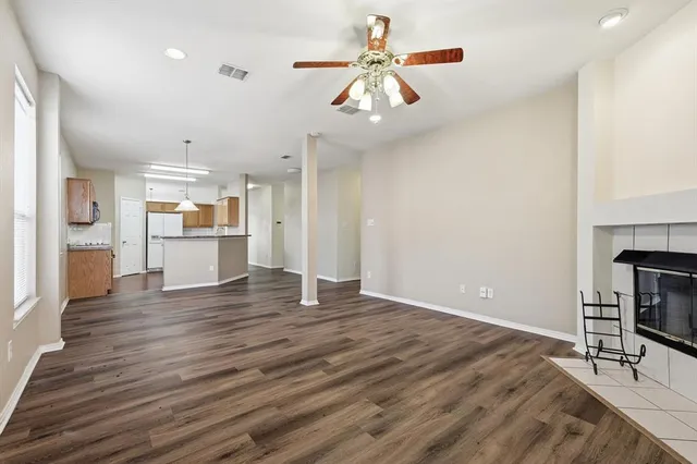 a view of a kitchen with a microwave and wooden floor
