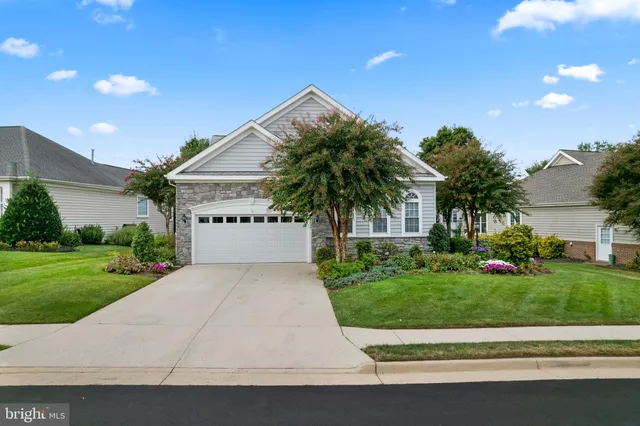a view of a house with a yard and potted plants