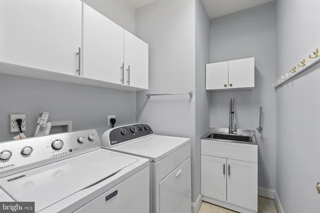 a kitchen with cabinets stove and a sink