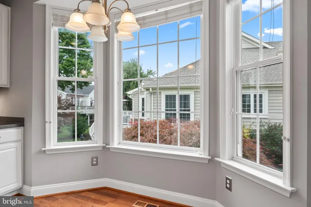 a kitchen with a refrigerator a stove top oven a sink and dishwasher with wooden floor