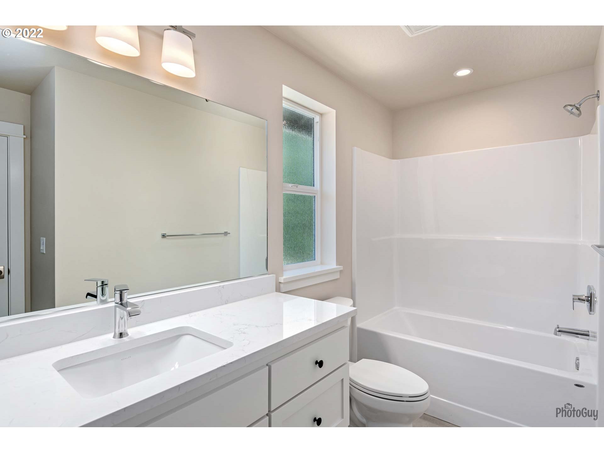 5319 High Banks Road Springfield, OR 97478 - Photo 29 of 32 a bathroom with a granite countertop sink a toilet a mirror a bathtub and shower