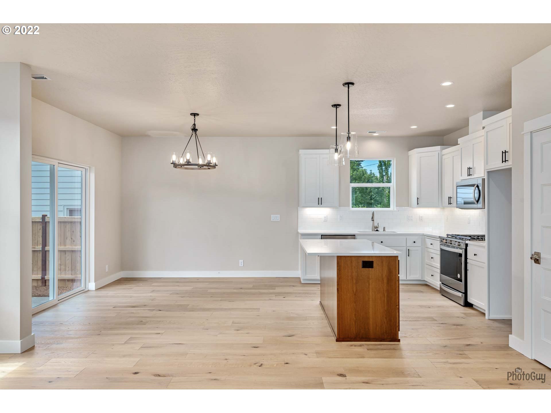 5319 High Banks Road Springfield, OR 97478 - Photo 8 of 32 a kitchen with kitchen island stainless steel appliances a sink cabinets and wooden floor