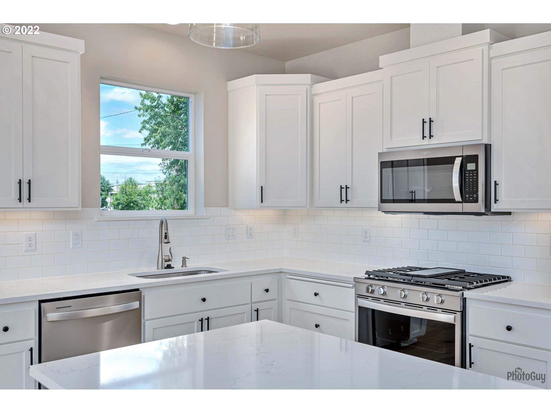 5319 High Banks Road Springfield, OR 97478 - Photo 10 of 32 a kitchen with stainless steel appliances white cabinets and a sink