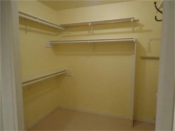 a view of an empty room with a fireplace and a window