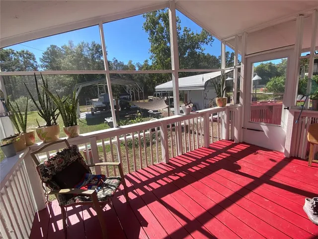 a kitchen with stainless steel appliances granite countertop a stove top oven a sink dishwasher a dining table and chairs with wooden floor