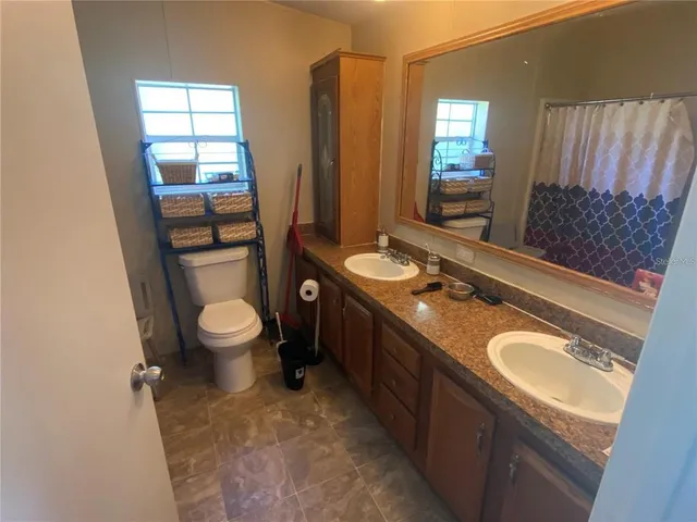 a view of a house with a backyard and a garden