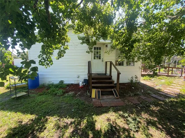 a view of a large garden with a house in the background
