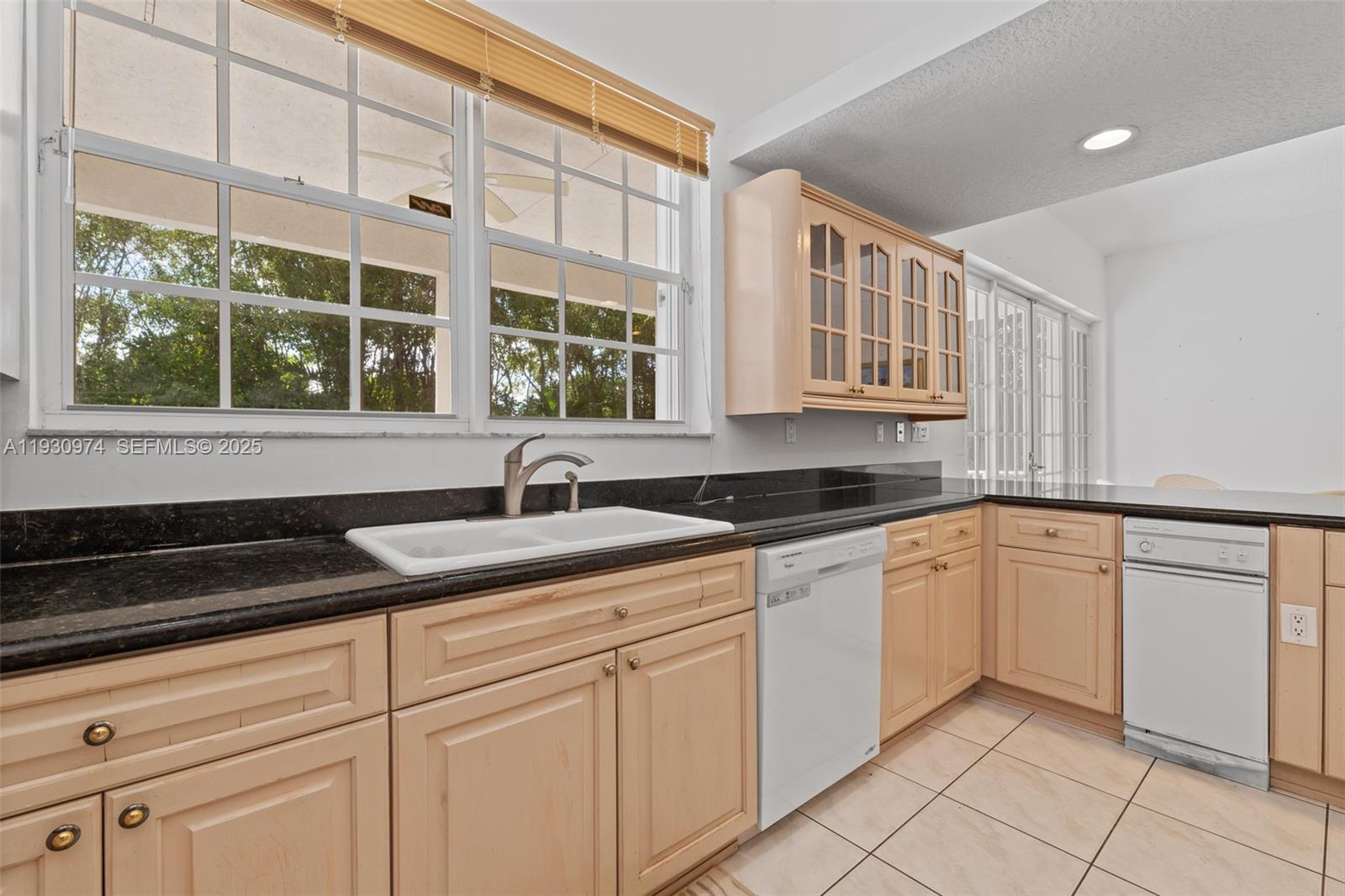 12982 Southwest 27th Street Miami, FL 33175 - Photo 14 of 43 a kitchen with stainless steel appliances granite countertop a sink and a white cabinets