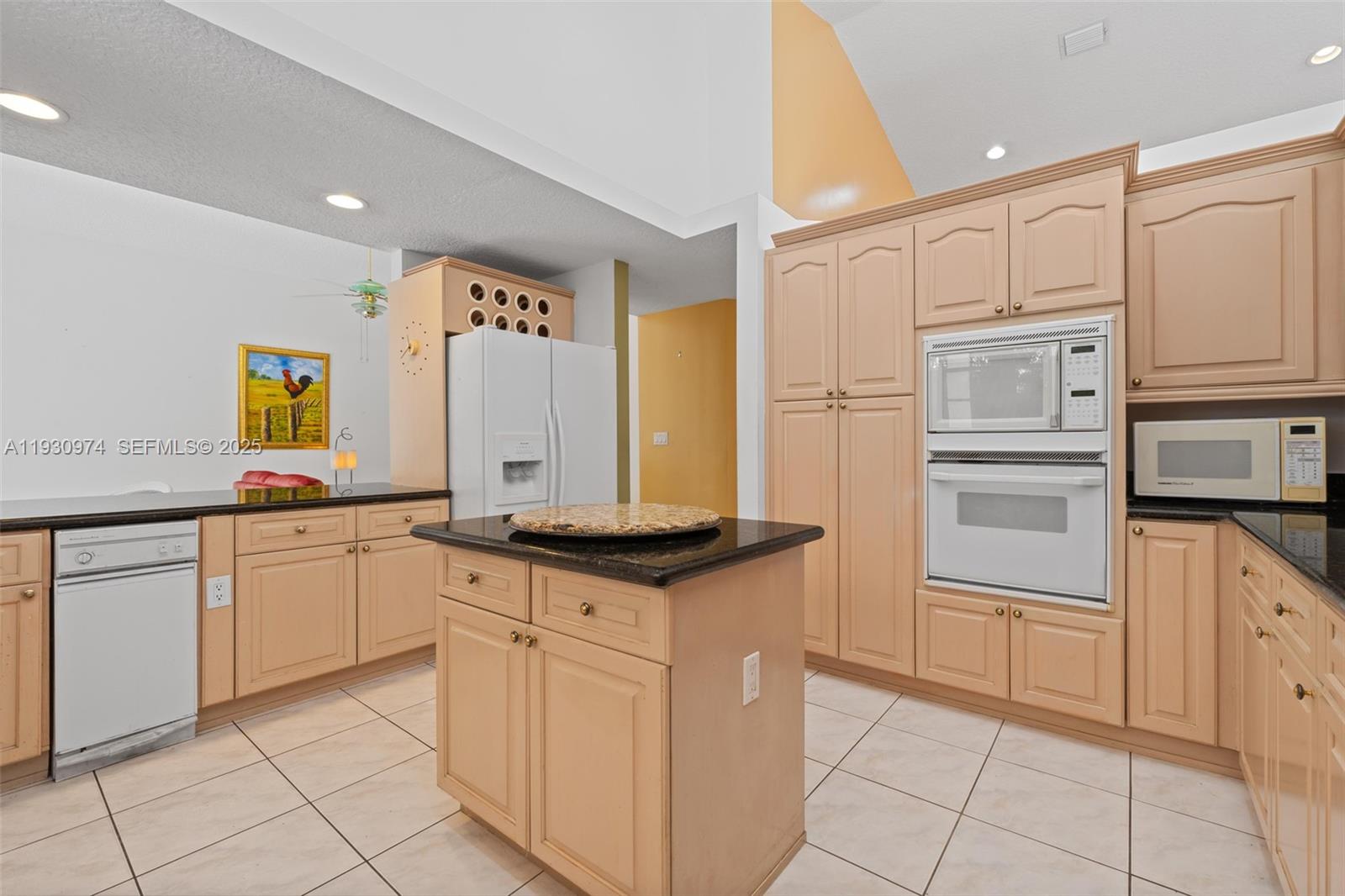 12982 Southwest 27th Street Miami, FL 33175 - Photo 15 of 43 a kitchen with granite countertop a sink and cabinets