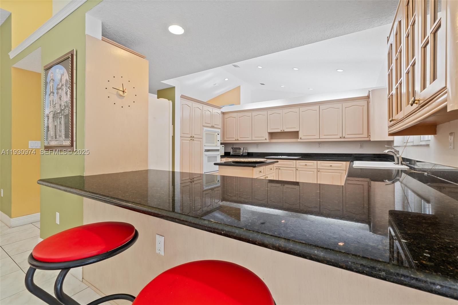 12982 Southwest 27th Street Miami, FL 33175 - Photo 16 of 43 a kitchen with stainless steel appliances granite countertop a sink and cabinets