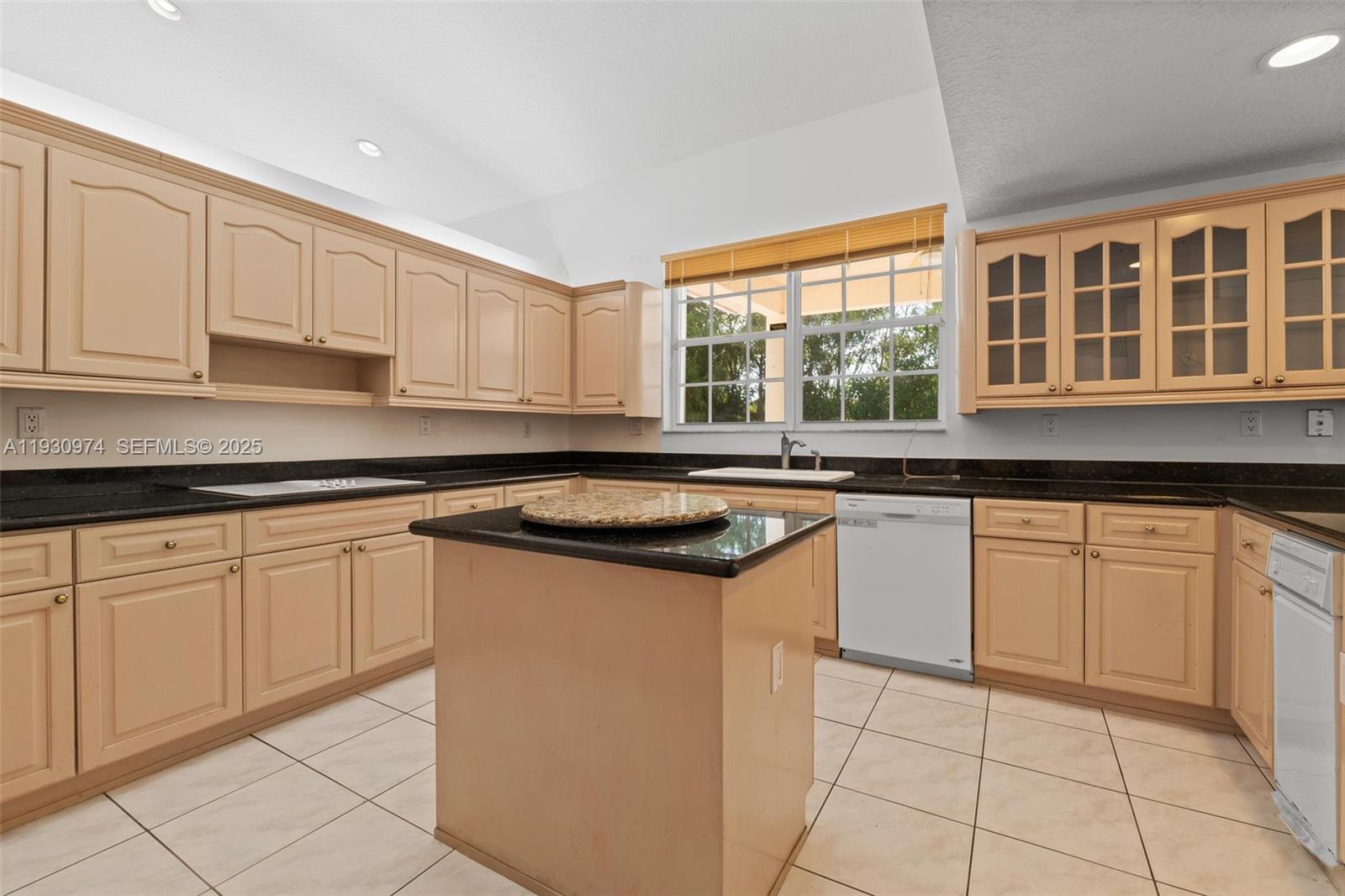 12982 Southwest 27th Street Miami, FL 33175 - Photo 17 of 43 a kitchen with stainless steel appliances granite countertop a sink and a stove