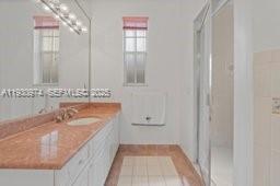 12982 Southwest 27th Street Miami, FL 33175 - Photo 29 of 43 a bathroom with a tub sink and mirror